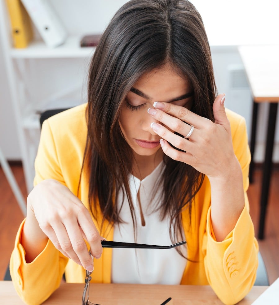 tired businesswoman sitting at her workplace PFM5KM4 E tu... fai colazione?